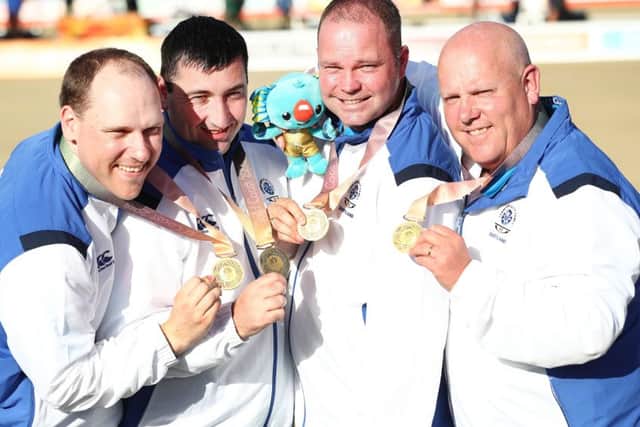 Alex Marshall, far right, celebrates gold with, from left, Ronald Duncan, Derek Oliver Paul Foster. PICTURE: Getty Images)