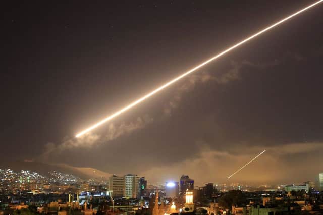 Damascus skies erupt with service to air missile fire as the U.S. launches an attack on Syria targeting different parts of the Syrian capital Damascus, Syria, early Saturday, April 14, 2018. Syria's capital has been rocked by loud explosions that lit up the sky with heavy smoke as U.S. President Donald Trump announced airstrikes in retaliation for the country's alleged use of chemical weapons. (AP Photo/Hassan Ammar)