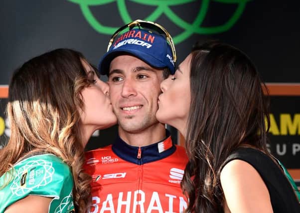 Cyclings Giro dItalia has no intention of getting rid of its podium girls who help winners celebrate. Photograph AFP/Getty Images