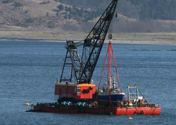 The Nancy Glen fishing trawler sits on a barge on Loch Fyne in Tarbert, Scotland after its recovery.  The capsized fishing boat sank on January 18 and resulted in the loss of fishermen Duncan MacDougall and Przemek Krawczyk.Picture; PA