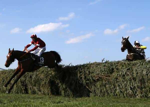 Tiger Roll ridden by Jockey Davy Russell (left) leads from Pleasant Company ridden by Jockey David Mullins (right) on the way to winning the Randox Health Grand National Handicap Chase.