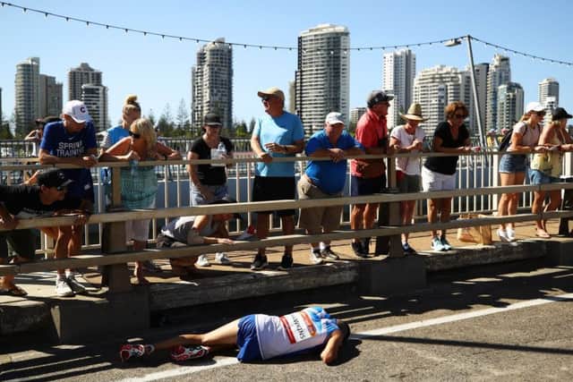 Callum Hawkins collapses with exhaustion near the end of the men's marathon in Gold Coast. PICTURE: Getty Images