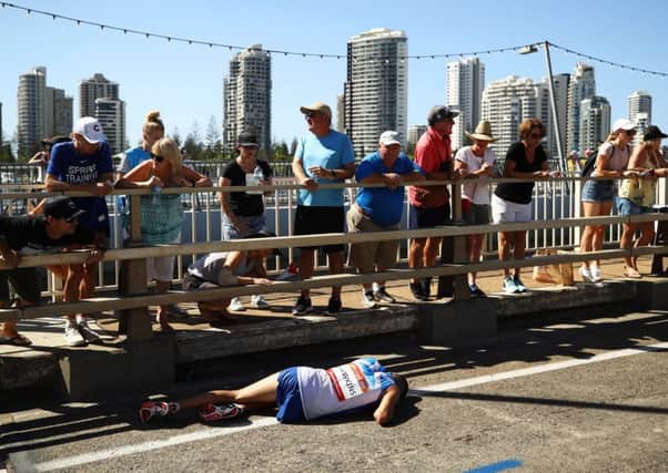 Callum Hawkins collapses with exhaustion near the end of the men's marathon in Gold Coast. Picture: Getty Images