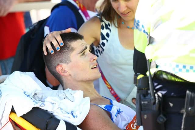 Callum Hawkins is comforted as he receives medical attention following his collapse in the men's marathon PICTURE: Getty Images