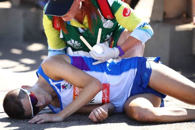 Callum Hawkins finally receives some medical attention after an agonising delay. PICTURE: Getty Images