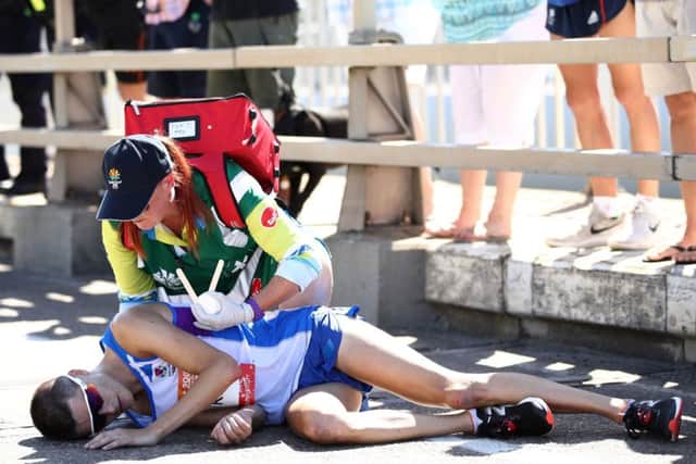 Callum Hawkins is given assistance after he collapsed in the Men's marathon on day 11 of the  2018 Commonwealth Games Picture: Cameron Spencer/Getty Images