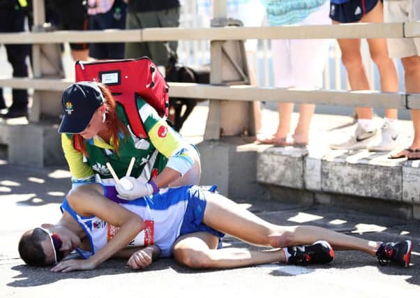 Callum Hawkins is given assistance after he collapsed in the Men's marathon on day 11 of the  2018 Commonwealth Games Picture: Cameron Spencer/Getty Images