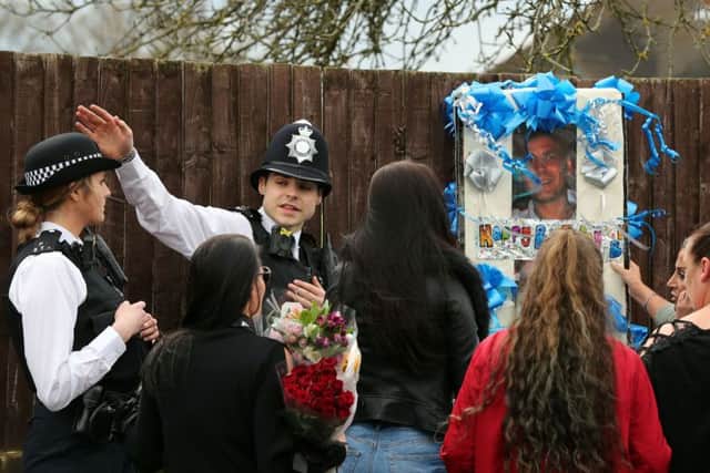 Police address friends and relatives of Henry Vincent as they bring birthday tributes to the scene on South Park Crescent in Hither Green, London. Picture: Gareth Fuller/PA Wire