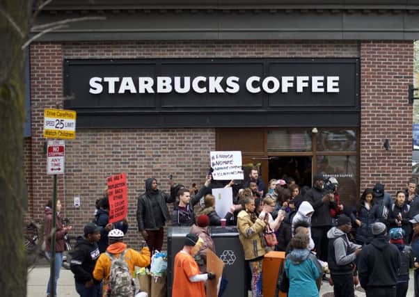 PHILADELPHIA, PA - APRIL 15:  Protestors demonstrate outside a Center City Starbucks in Philadelphia after police arrested two black men who were waiting inside the coffee shop. Picture: Mark Makela/Getty