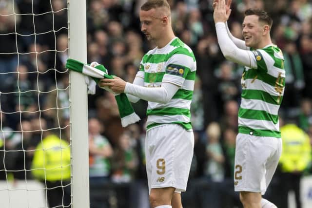 Leigh Griffiths ties a Celtic scarf to the goalpost after the match. Picture: SNS Group