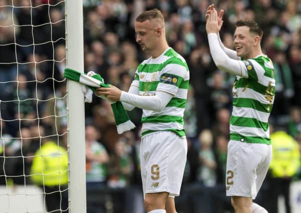 Leigh Griffiths ties a Celtic scarf to the goalpost after the match. Picture: SNS Group