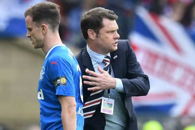 Andy Halliday trudges past Graeme Murty after being substituted before half time. Picture: SNS Group