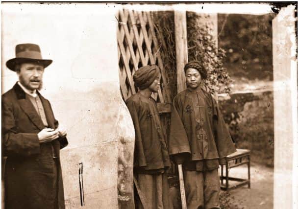 Thomson with two Manchu soldiers, Xiamen, Fujian.  Amoy, or Xiamen, was the southern frontier of the Qing empire.