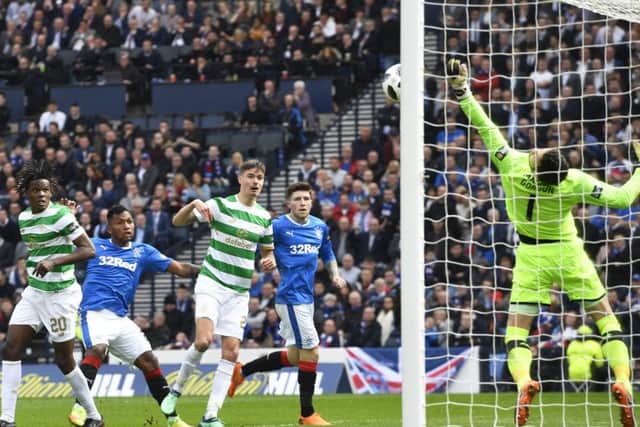 Celtic's Craig Gordon produces a spectacular save to flick a header from Rangers striker Alfredo Morelos over the bar.
