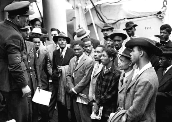 Jamaican immigrants are welcomed by RAF officials from the Colonial Office after the ex-troopship Empire Windrush landed them at Tilbury in 1948. Picture: PA