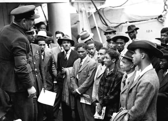 Passengers from the HMT Empire Windrush are welcomed by RAF officials after theiri arrival in Britain in 1948.