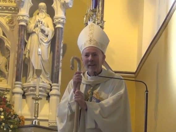 Bishop William Nolan addresses the congregation of Holy Family Church