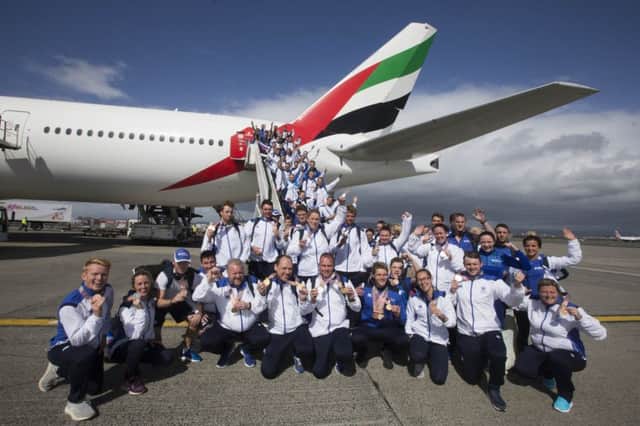 Team Scotland pose with their medals at Glasgow Airport after arriving back in the country. Picture: Jeff Holmes