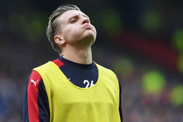 Rangers striker Jason Cummings looks dejected after being an unused substitute in his side's 4-0 Scottish Cup semi-final defeat by Celtic at Hampden. Picture: SNS