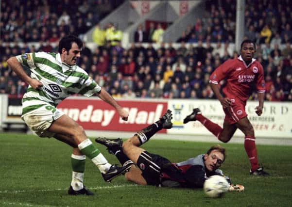 Darren Jackson fires the ball past Jim Leighton to score against Aberdeen during Celtic's title-winning season in 1997-98. Picture: SNS