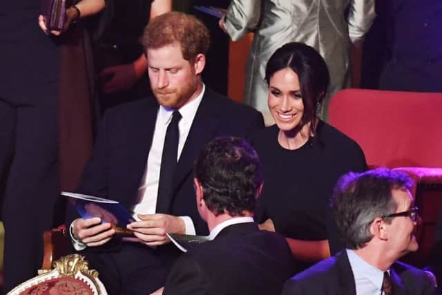Prince Harry and Meghan Markle take their seats at a star-studded concert to celebrate the Queen's 92nd birthday at the Royal Albert Hall. Picture: John Stillwell