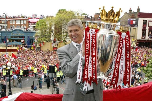 Arsenal manager Arsene Wenger, who is stepping down at the end of the season, is pictured with the Premiership trophy following the club's unbeaten league season in 2003/04. Picture: PA Wire