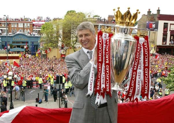 Arsenal manager Arsene Wenger, who is stepping down at the end of the season, is pictured with the Premiership trophy following the club's unbeaten league season in 2003/04. Picture: PA Wire
