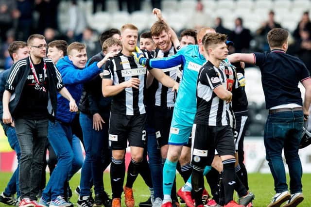 St Mirren players and the fans who bankroll them celebrate winning promotion. Picture: SNS.