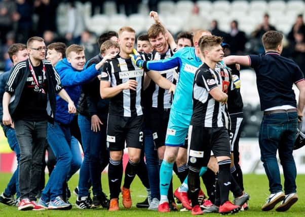 St Mirren players and the fans who bankroll them celebrate winning promotion. Picture: SNS.