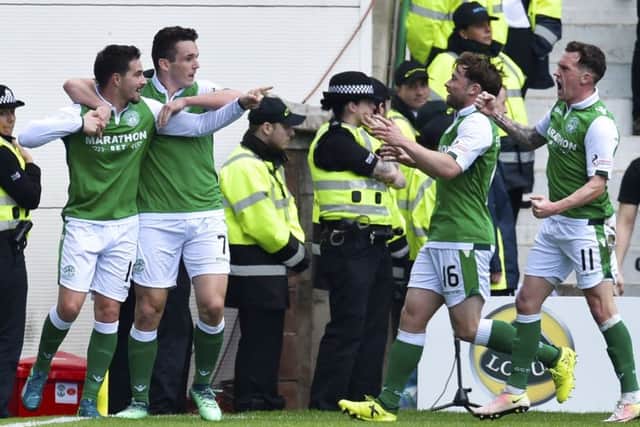 Jamie MacLaren (left) celebrates with his Hibs team-mates after opening the scoring. Picture: SNS