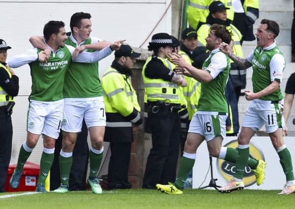 Jamie MacLaren (left) celebrates with his Hibs team-mates after opening the scoring. Picture: SNS