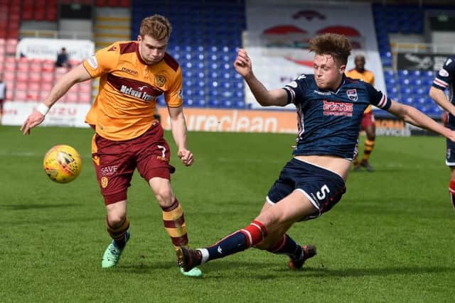 Harry Souttar attempts to challenge Motherwell midfielder Chris Cadden. Picture: SNS