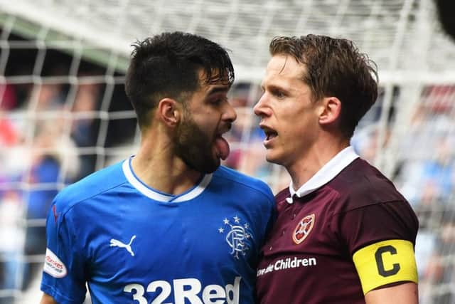 Hearts skipper Christophe Berra stands up to Daniel Candeias. Picture: SNS.