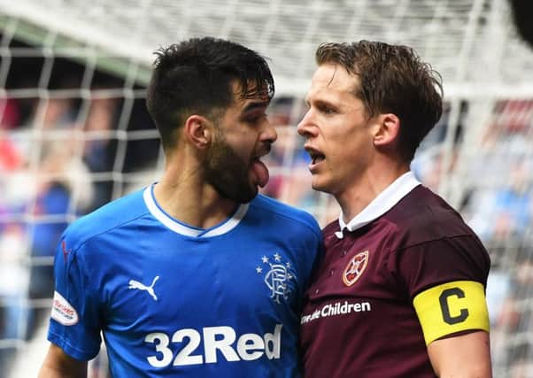 Hearts skipper Christophe Berra stands up to Daniel Candeias. Picture: SNS.