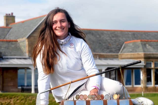 Stoke-by-Nayland's Lily May Humphreys poses with the Helen Holm Trophy in front of the Royal Troon clubhouse. Picture: Derek McCabe