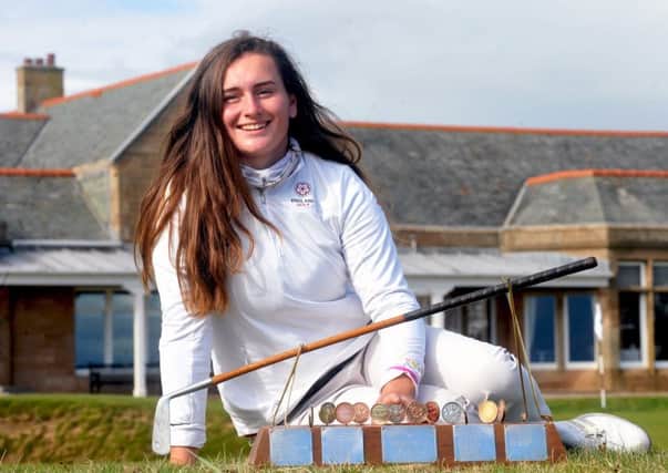 Stoke-by-Nayland's Lily May Humphreys poses with the Helen Holm Trophy in front of the Royal Troon clubhouse. Picture: Derek McCabe