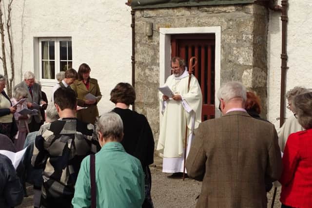 Reverend Mark Strange performs a blessing at The Crask Inn for owners. Picture: SWNS