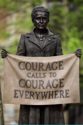 People pose for photographs with a statue of suffragist and women's rights campaigner Millicent Fawcett by British artist Gillian Wearing after it was unveiled in Parliament Square in London on April 24, 2018.
The first statue of a woman on Parliament Square in London was to be unveiled on April 24 to celebrate the 100th anniversary of women winning the right to vote in Britain. The statue of women's rights campaigner Millicent Fawcett will stand alongside those of 11 men, including Britain's wartime leader Winston Churchill, Indian independence icon Mahatma Gandhi and anti-apartheid leader Nelson Mandela. / AFP PHOTO / Adrian DENNISADRIAN DENNIS/AFP/Getty Images