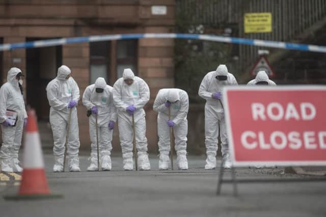 Forensics at the scene of the shooting on Bilsland Drive. Picture: John Devlin
