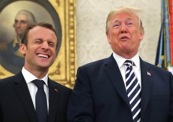 Emmanuel Macron and Donald Trump appear to be getting along famously despite the French President's snubs and criticism of his US counterpart (Picture: AP)