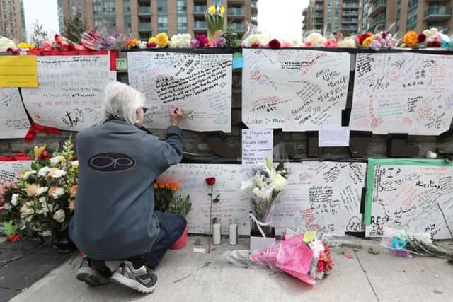 Mourners have put together a makeshift memorial to the victims. Picture: AFP/Getty Images
