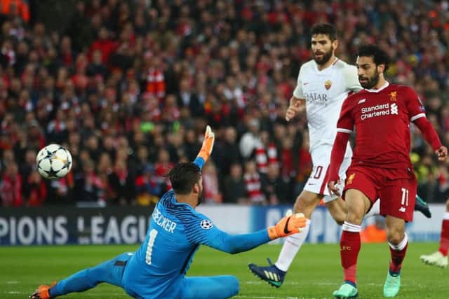 Salah lifts the ball over Roma keeper Alisson to give Liverpool a 2-0 lead on the stroke of half-time