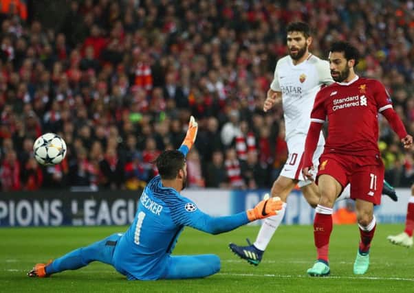 Salah lifts the ball over Roma keeper Alisson to give Liverpool a 2-0 lead on the stroke of half-time