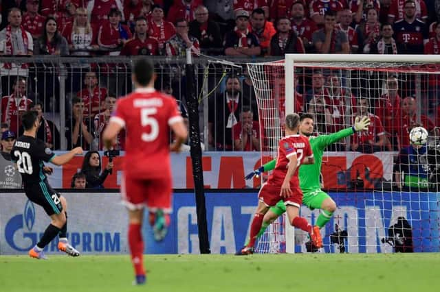 Marco Asensio fires the ball past Bayern Munich goalkeeper Sven Ulreich to clinch Real Madrids victory in the Allianz Arena. Picture: AFP/Getty
