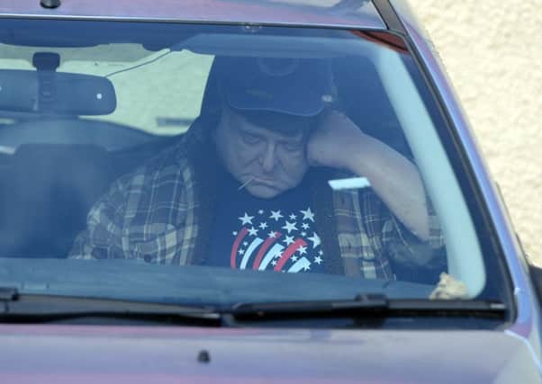 A silicone version of the actor John Goodman sits in the car park of Bill's Tool Store. Picture: SWNS
