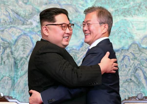 North Korean leader Kim Jong Un (L) and South Korean President Moon Jae-in (R) embrace after signing the Panmunjom Declaration for Peace, Prosperity and Unification of the Korean Peninsula. Caption: Getty