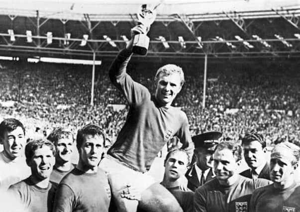 Traditionalists pine for the old Wembleys inspiring history including Bobby Moore with the Jules Rimet trophy. Picture: AFP/Getty Images