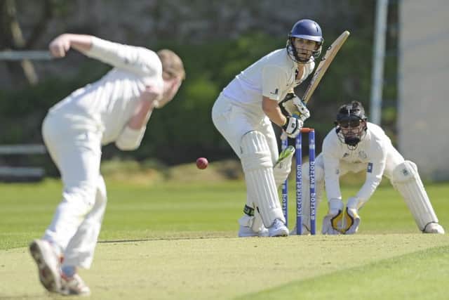 Ally Sadler bowls to Michael Sean of Heriot's on his way to scoring an unbeaten 92 at the crease with RHC's wicketkeeper Elliot Foster standing up to the wicket. Photograph:
Neil Hanna Photography
