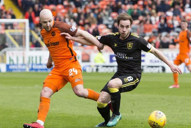Dundee United's Grant Gillespie comptes with Livingston's Scott Pittman. Picture: SNS/Bruce White