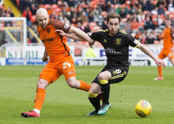 Dundee United's Grant Gillespie comptes with Livingston's Scott Pittman. Picture: SNS/Bruce White